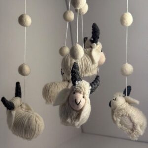 Felted wool sheep and bunnies hanging from a nursery mobile